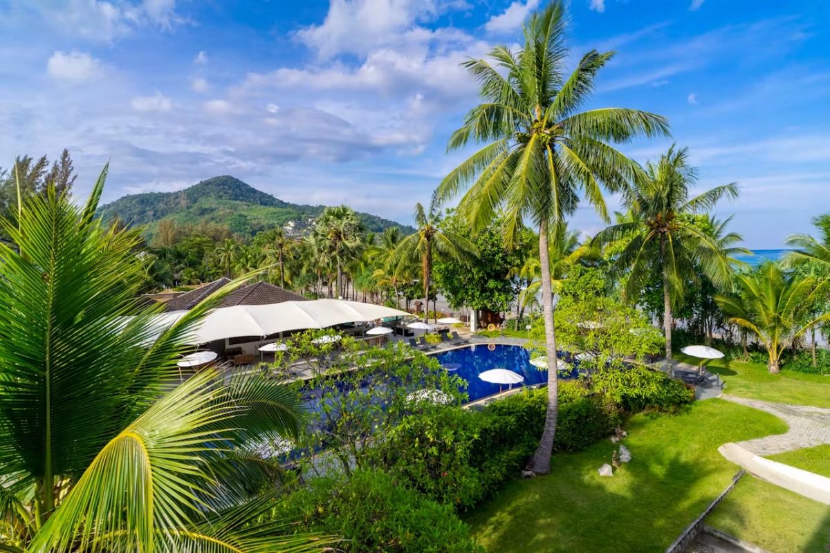 Tropical gardens and swimming pool at Sunprime Kamala Beach Resort Phuket