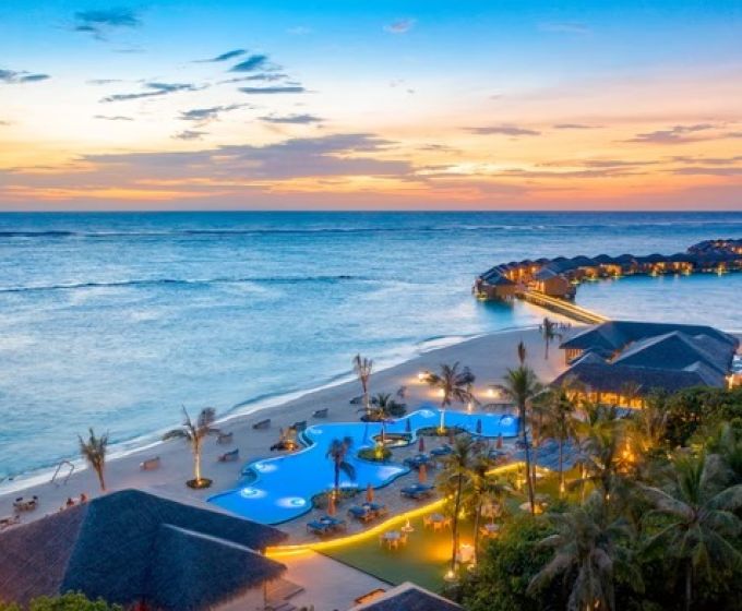 You & Me Cocoon Maldives resort and lagoon at sunset