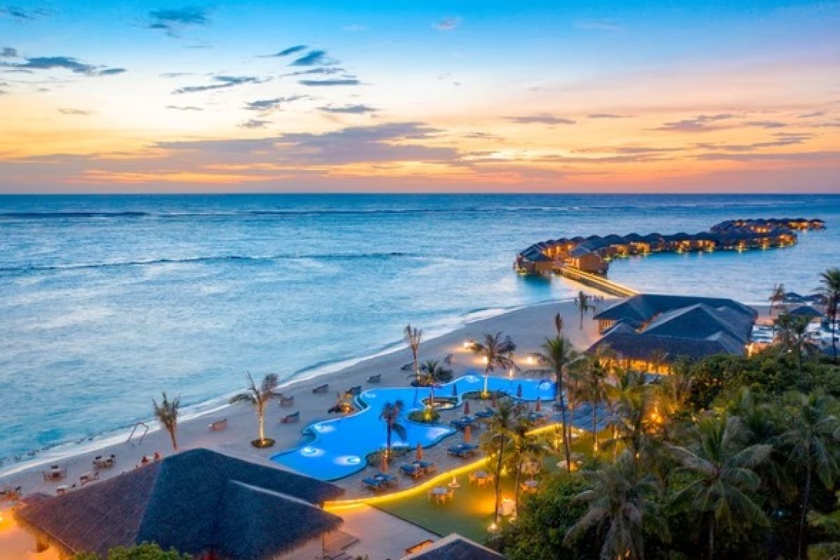 You & Me Cocoon Maldives resort and lagoon at sunset