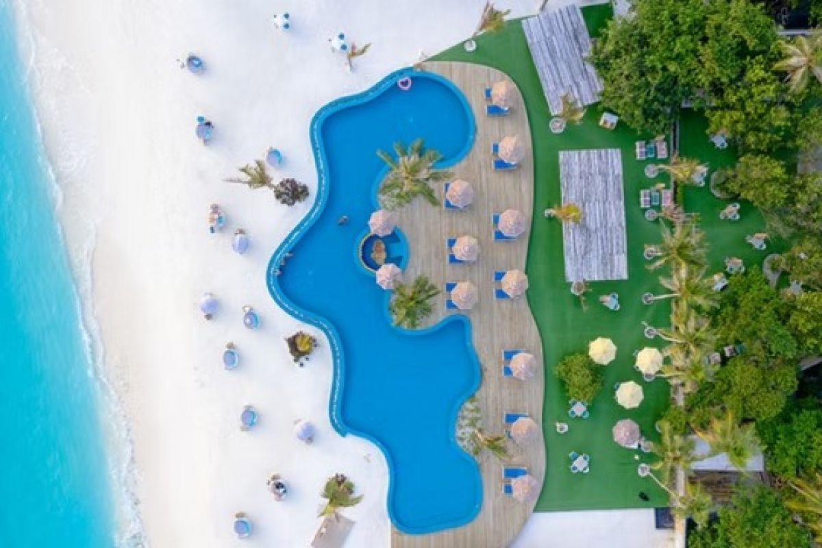 You & Me Cocoon Maldives beach and swimming pool surrounded by turquoise waters