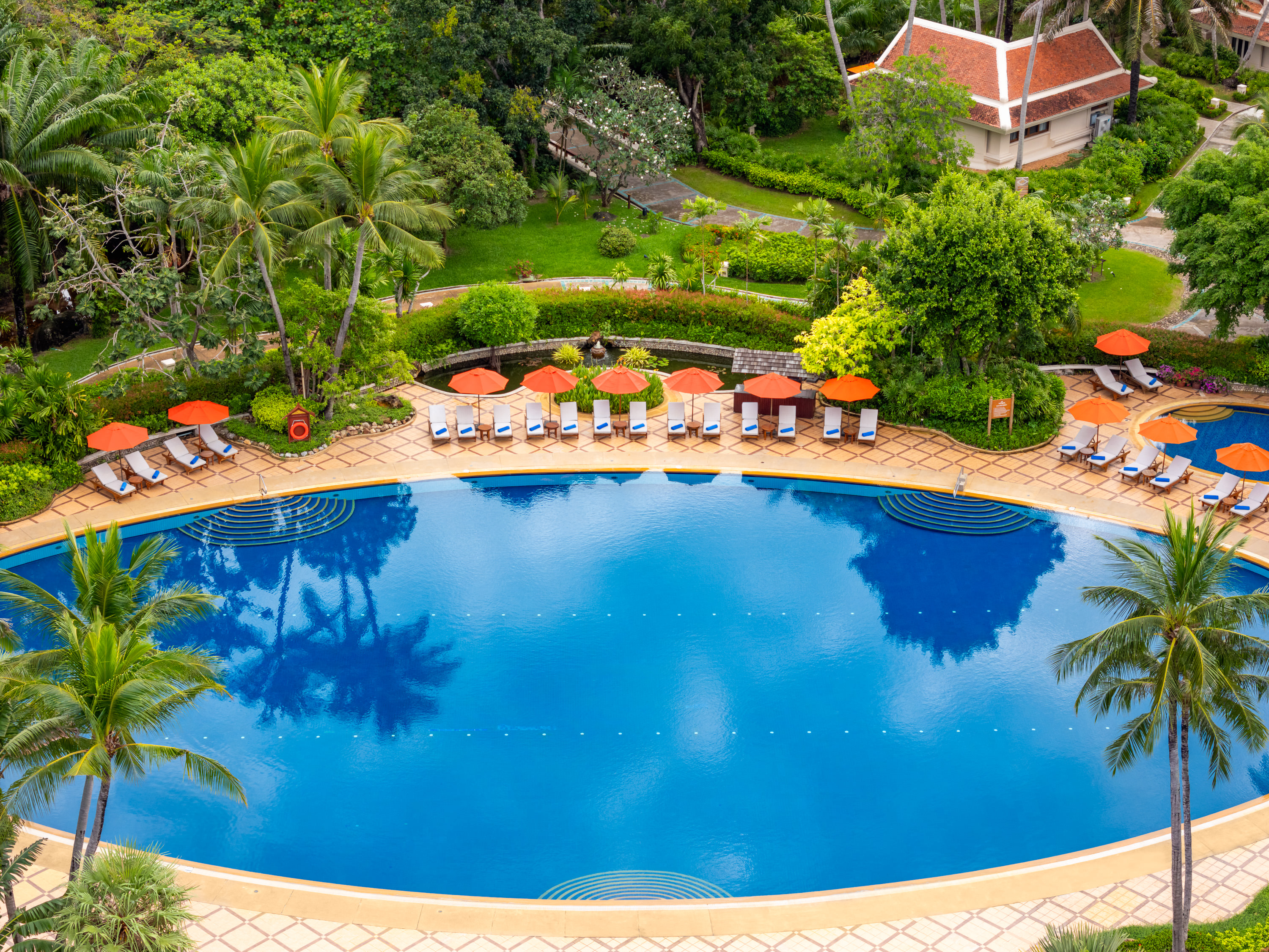 Large swimming pool surrounded by tropical gardens at Santiburi Koh Samui