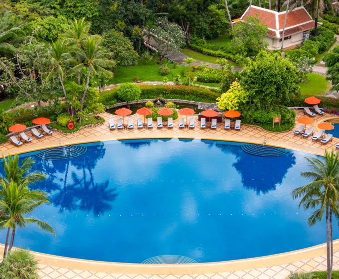 Large swimming pool surrounded by tropical gardens at Santiburi Koh Samui