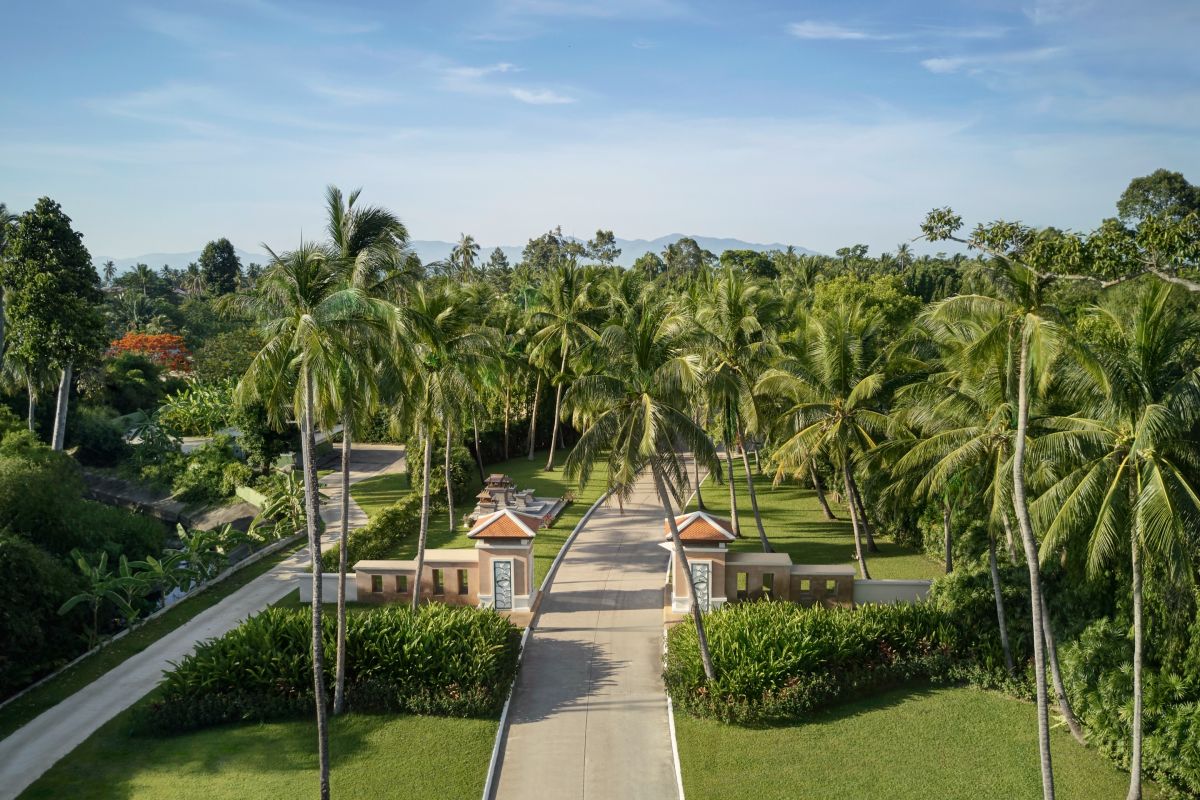 Tropical gardens and palm-lined entrance at Santiburi Koh Samui