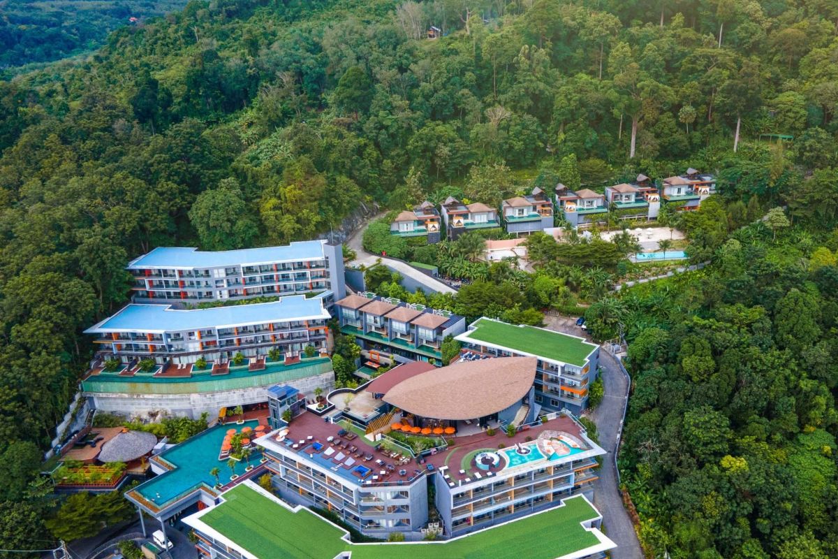 Kalima Resort & Spa Phuket surrounded by lush tropical hillside