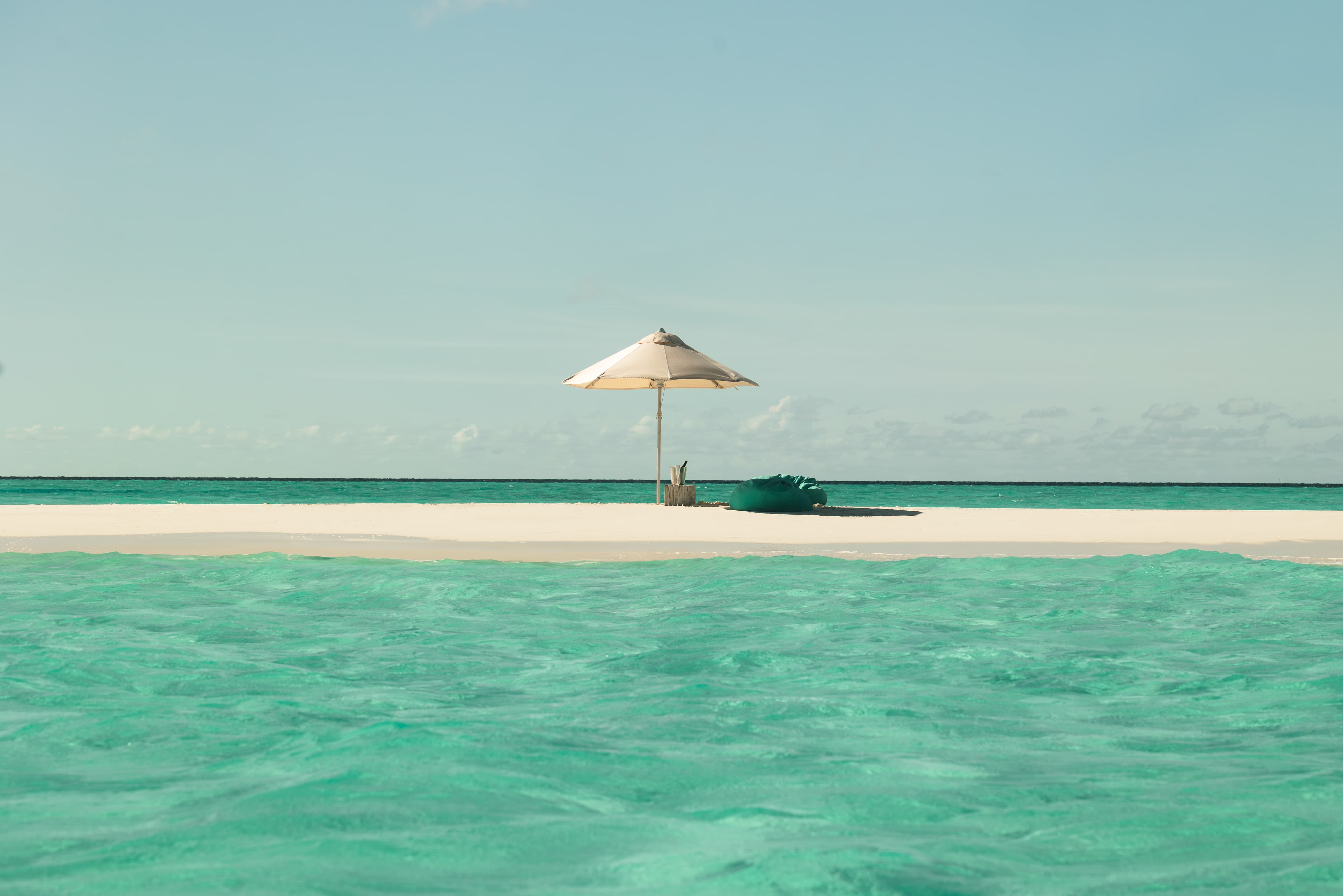 White sand beach and turquoise lagoon at Sun Siyam Iru Veli Maldives
