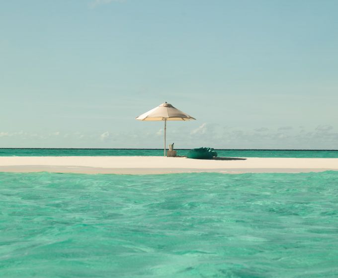 White sand beach and turquoise lagoon at Sun Siyam Iru Veli Maldives