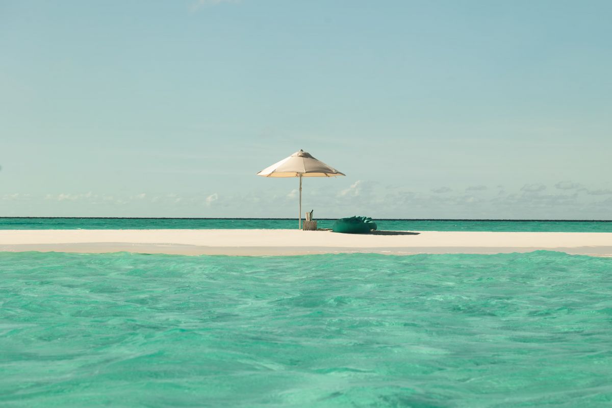 White sand beach and turquoise lagoon at Sun Siyam Iru Veli Maldives