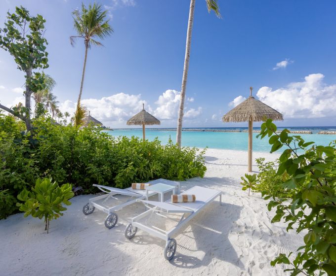Joy Island Maldives Beach Villa exterior with tropical garden and sea view