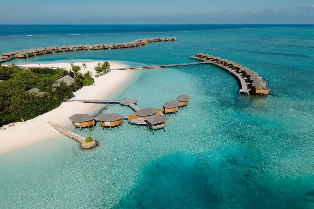 You & Me Cocoon Maldives aerial view with turquoise lagoon and overwater villas