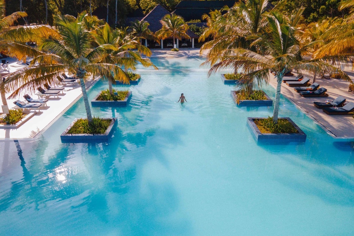 Luxury resort pool surrounded by tropical scenery in the Maldives