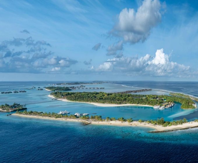 Aerial view of a tropical Maldives island surrounded by turquoise waters