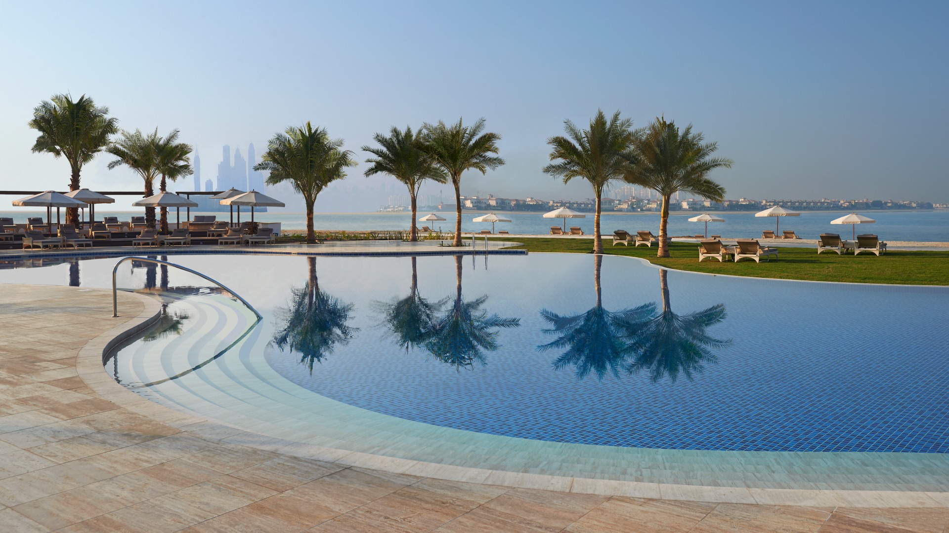 Waldorf Astoria Dubai Palm Jumeirah beachfront swimming pool with Dubai skyline views