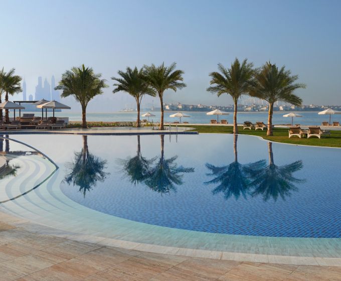 Waldorf Astoria Dubai Palm Jumeirah beachfront swimming pool with Dubai skyline views