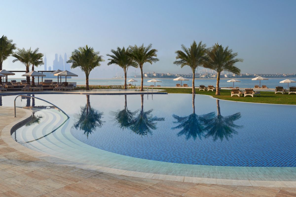 Waldorf Astoria Dubai Palm Jumeirah beachfront swimming pool with Dubai skyline views