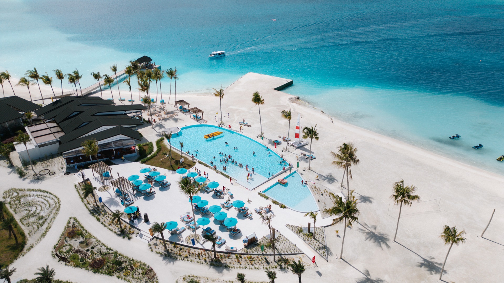 Joy Island Maldives resort aerial view with swimming pool and beach