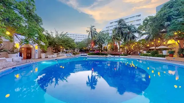 The Sens Cancun By Oasis swimming pool surrounded by tropical gardens
