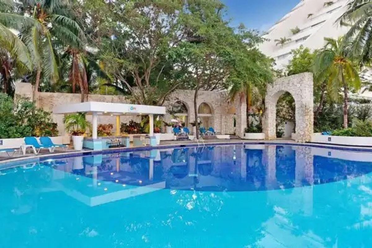Tropical swimming pool and landscaped gardens at a Cancun resort