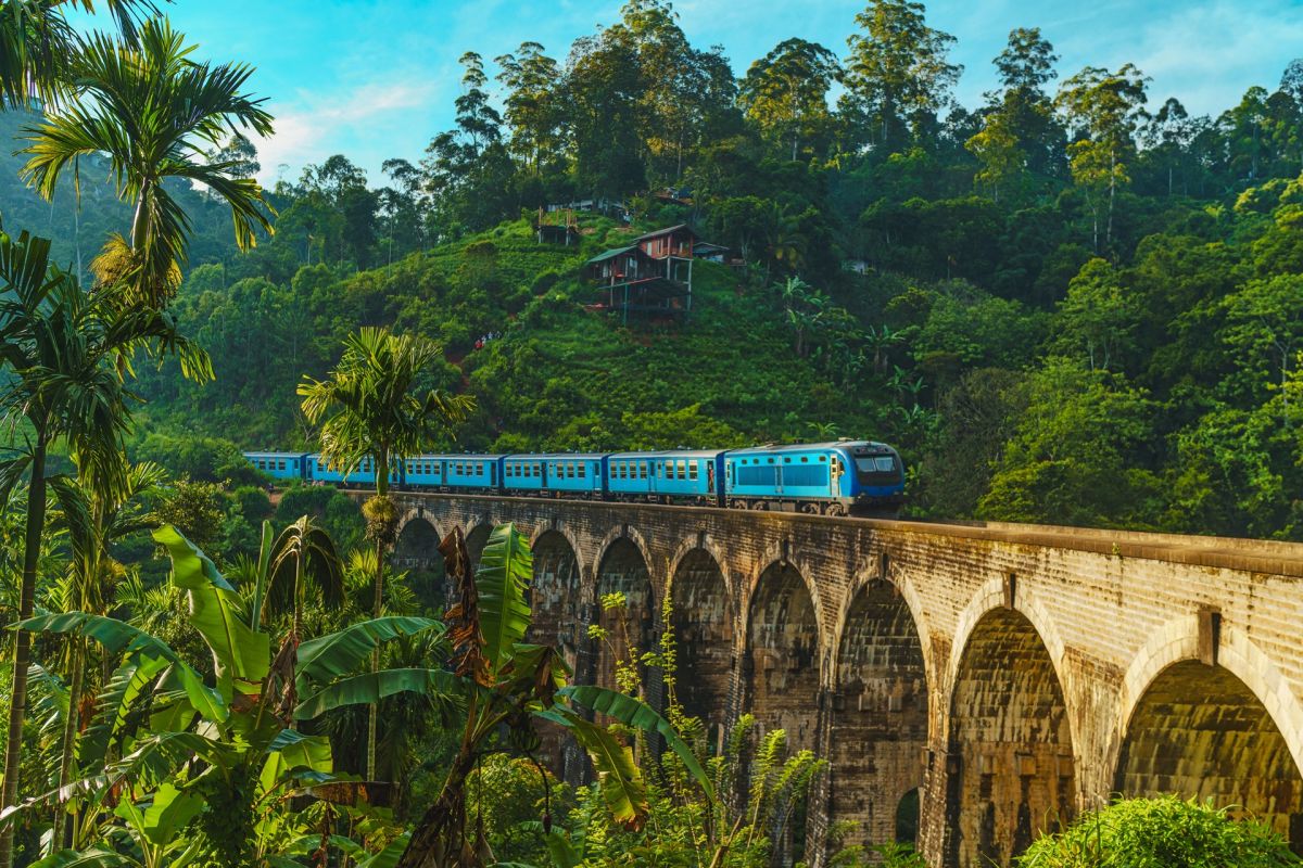 Scenic train crossing the Nine Arch Bridge in Sri Lanka hill country