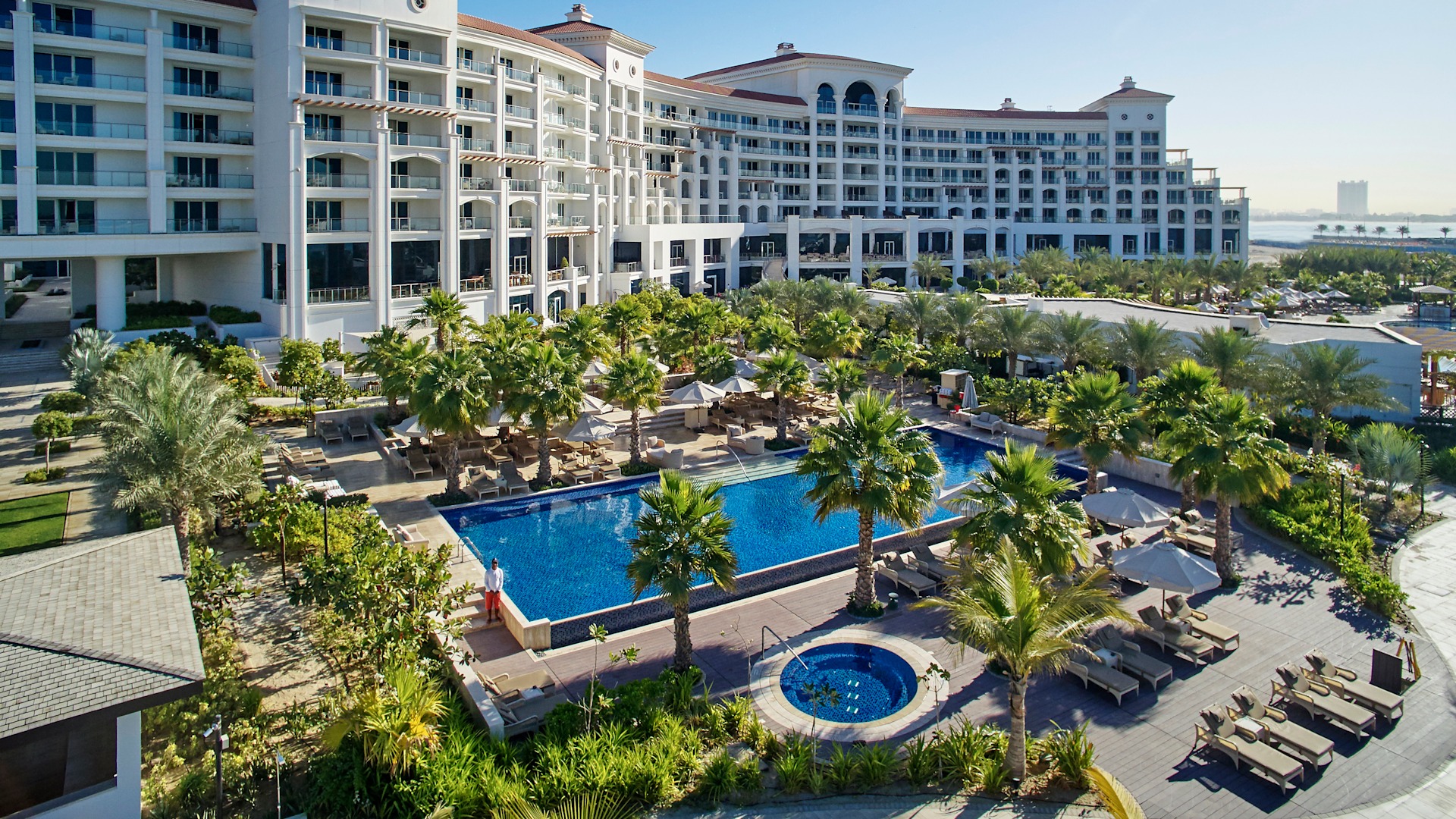 Waldorf Astoria Dubai Palm Jumeirah swimming pool surrounded by tropical gardens