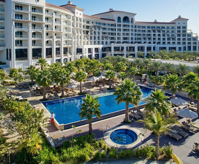 Waldorf Astoria Dubai Palm Jumeirah swimming pool surrounded by tropical gardens