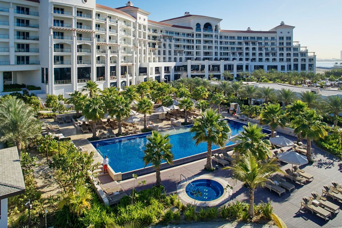 Waldorf Astoria Dubai Palm Jumeirah swimming pool surrounded by tropical gardens