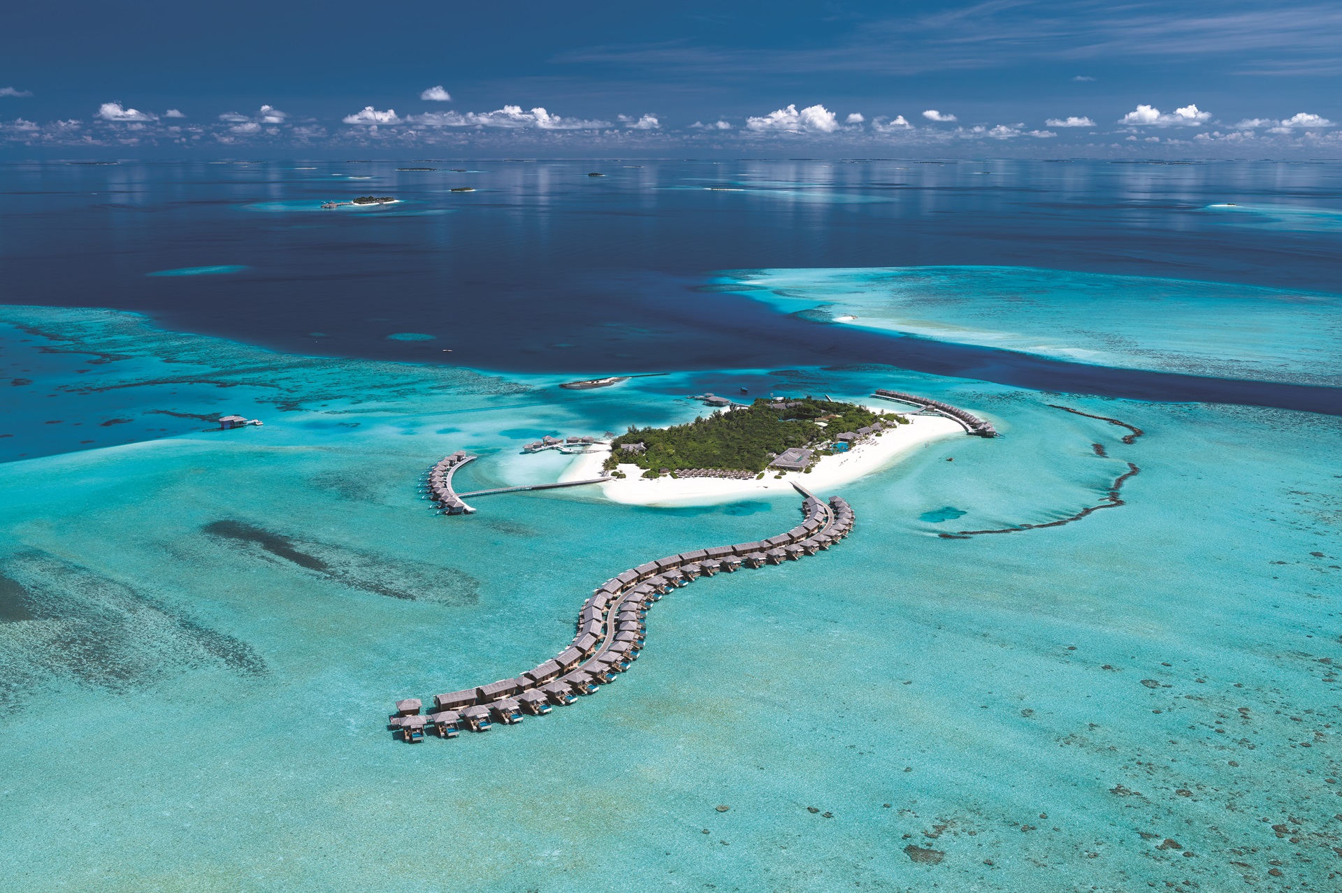 You & Me Cocoon Maldives aerial view with overwater villas and turquoise lagoon