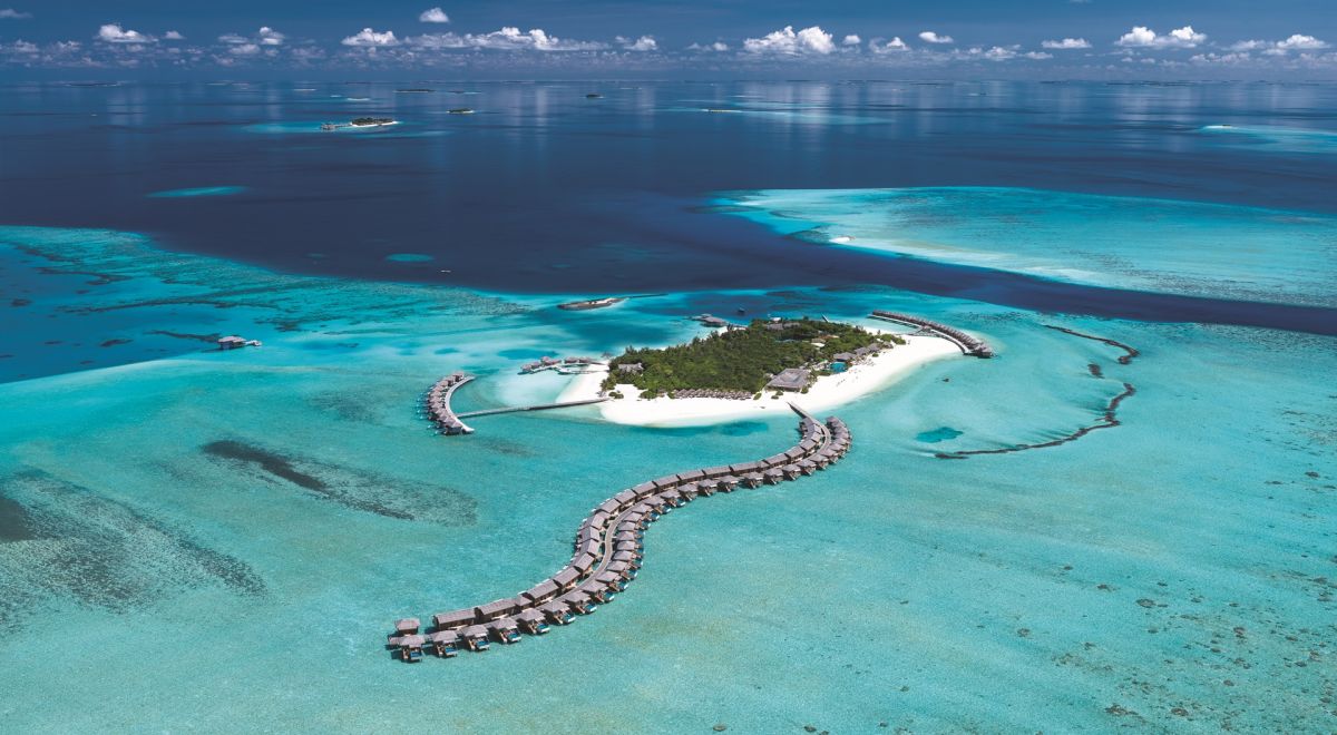 You & Me Cocoon Maldives aerial view with overwater villas and turquoise lagoon