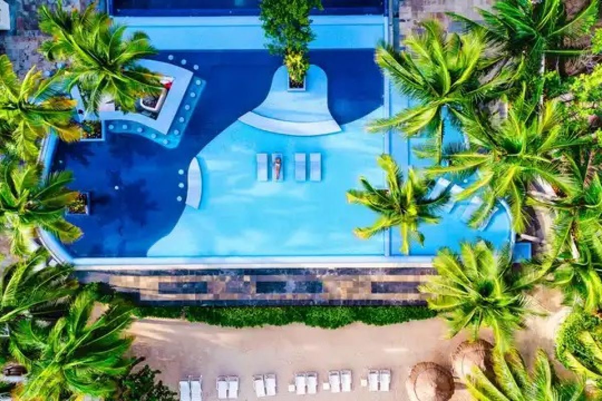 Aerial view of tropical swimming pool and palm trees at a Cancun resort